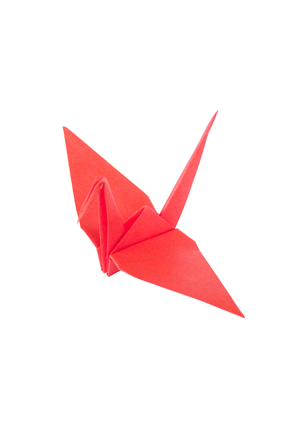 Red Origami Paper Crane On Red Background Closeup High-Res Stock